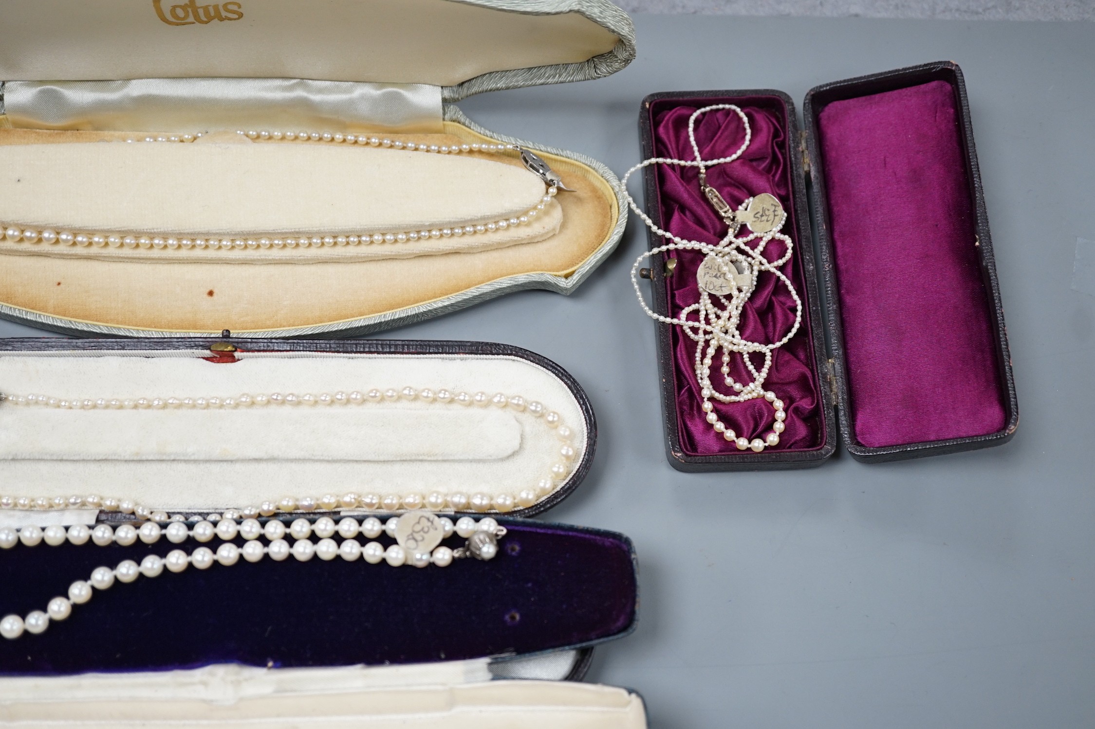 Six assorted single strand graduated cultured pearl necklaces, with marcasite or paste set clasps, longest 64cm and two small seed pearl necklaces, one with rose cut diamond and seed pearl set clasp.
